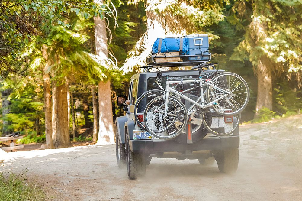 A car outfitted with gear and bikes