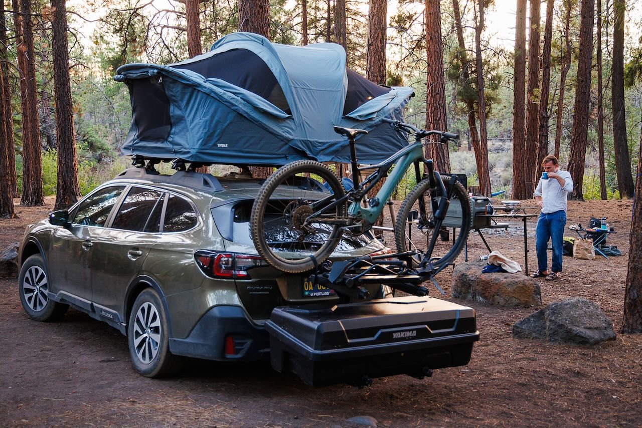 Hitch mounted cargo system loaded with bikes and camping gear