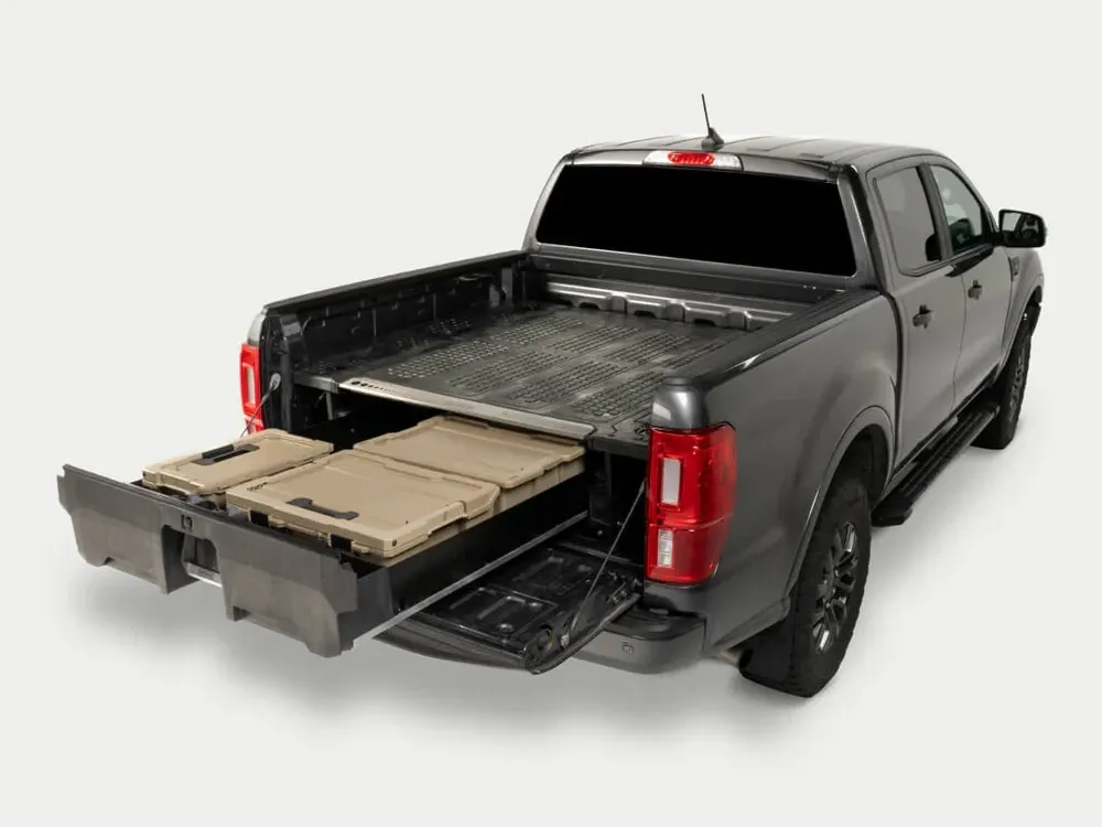 A pickup truck with an in-bed storage drawer organizer system