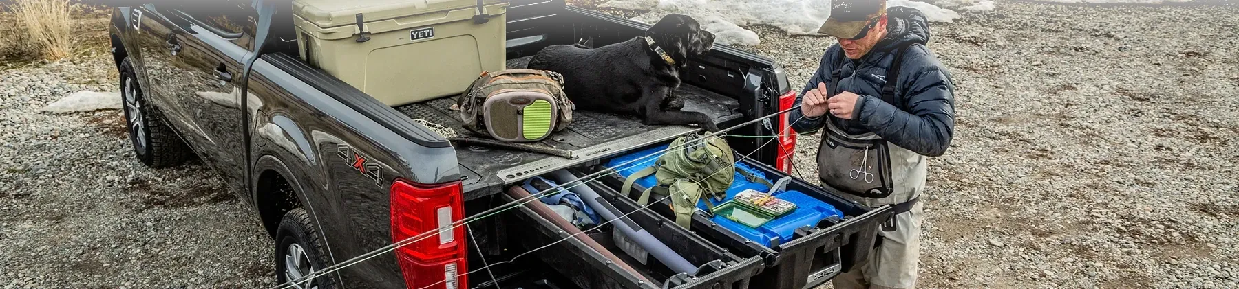 a truck with a bed organizer with pull-out drawers and tackle boxes