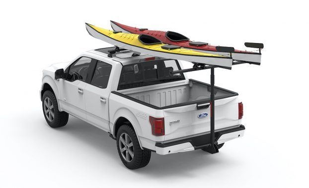 A truck carrying two kayaks