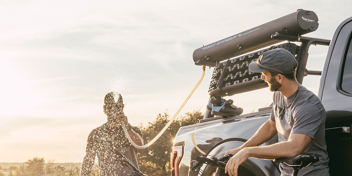 A rack mounted camp site shower spraying water